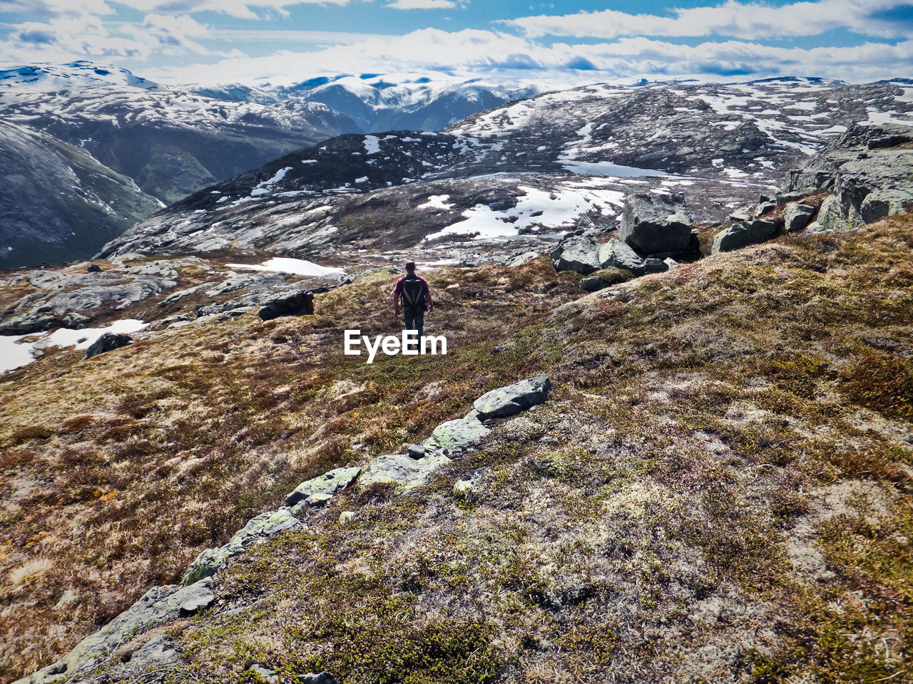 Rear view of man standing on mountain