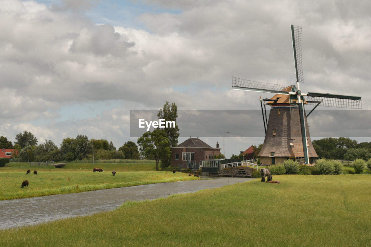 Traditional windmill on field against sky holand 