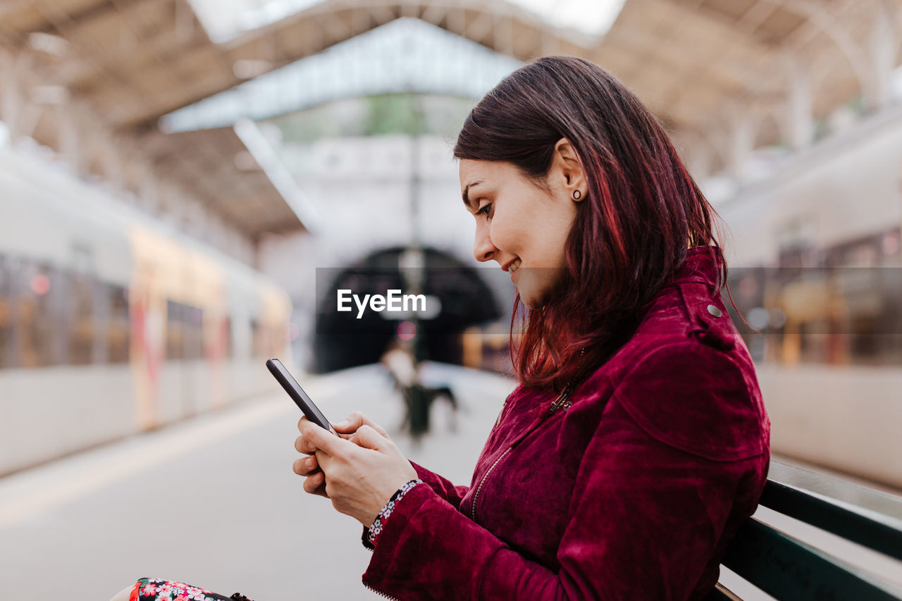 Smiling woman using mobile phone