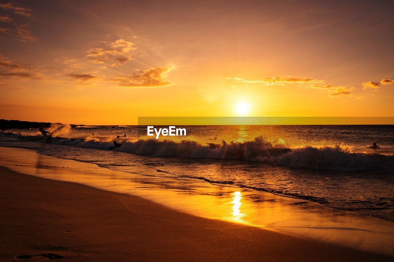 View of calm beach at sunset