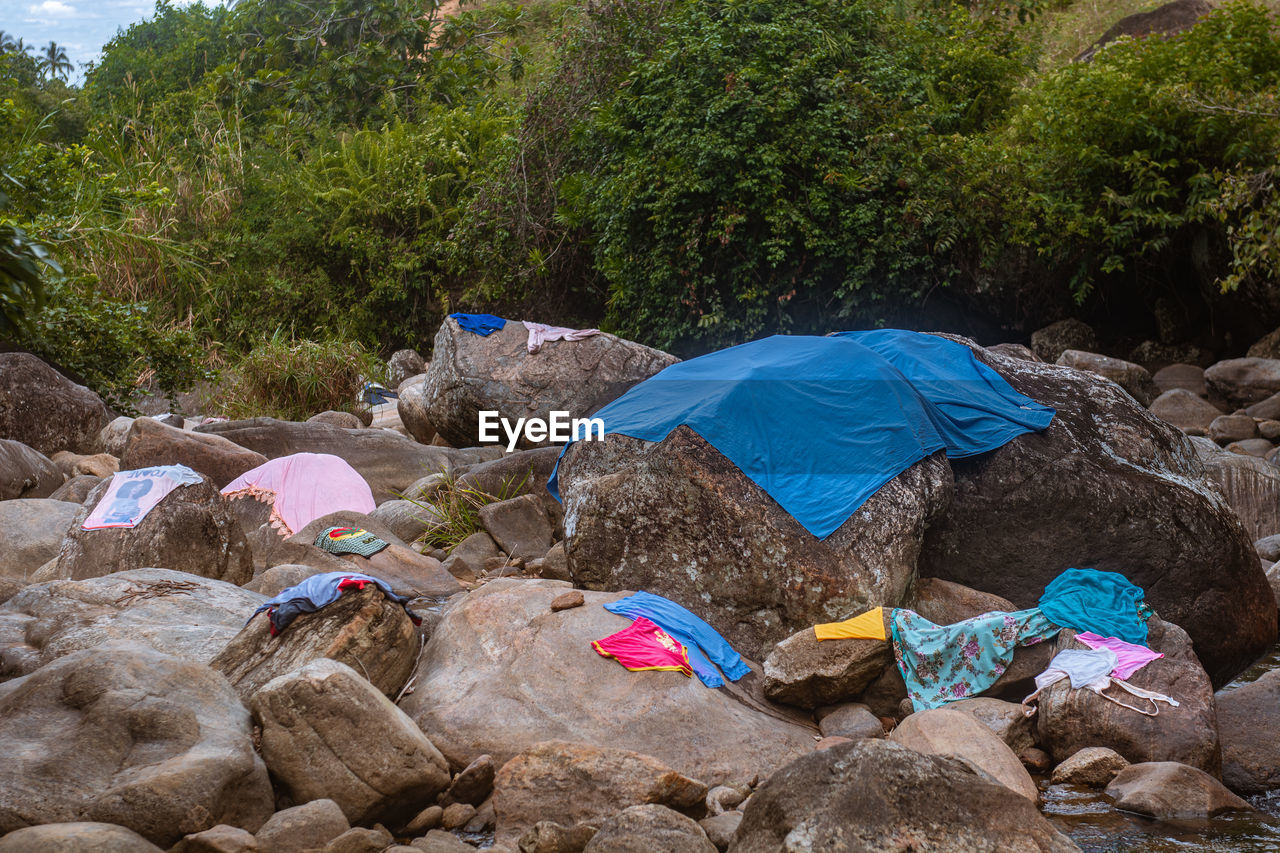 Clothes put on boulders and stones to dry in rural area