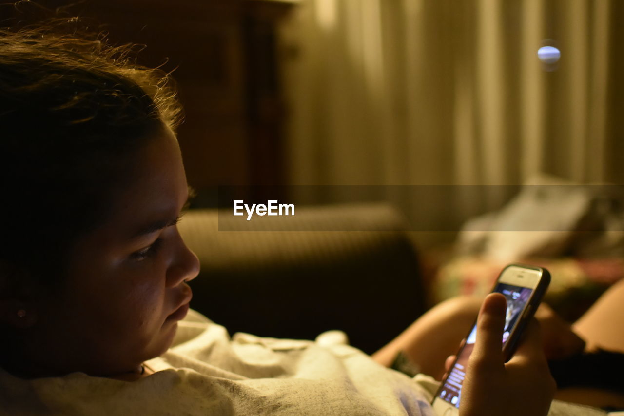 Young woman using smart phone at home