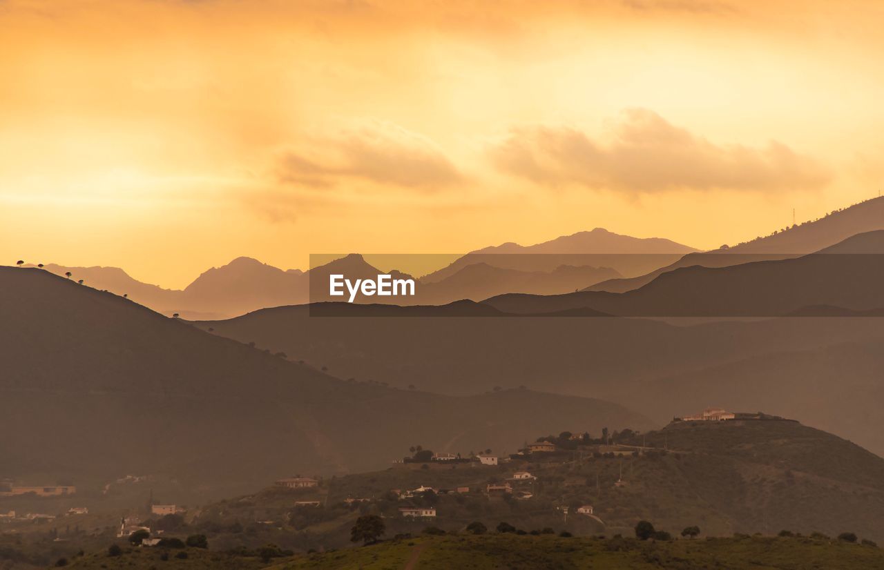 Scenic view of silhouette mountains against sky during sunset