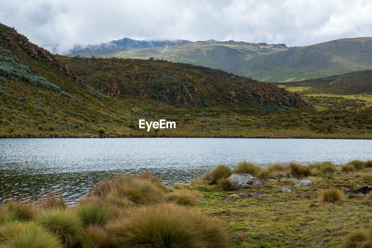 Lake ellis against mountains at chogoria route, mount kenya national park, kenya