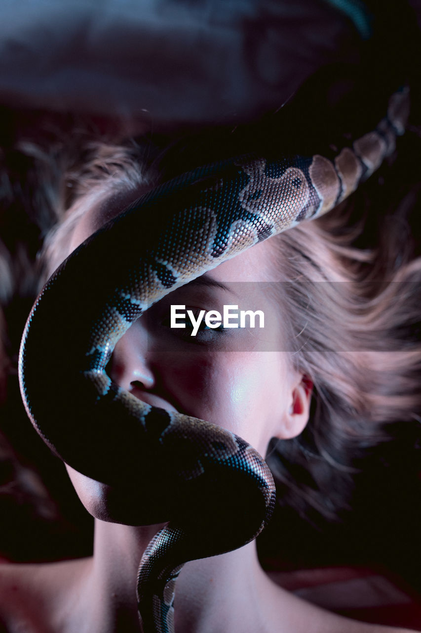 cropped hand of woman with snake