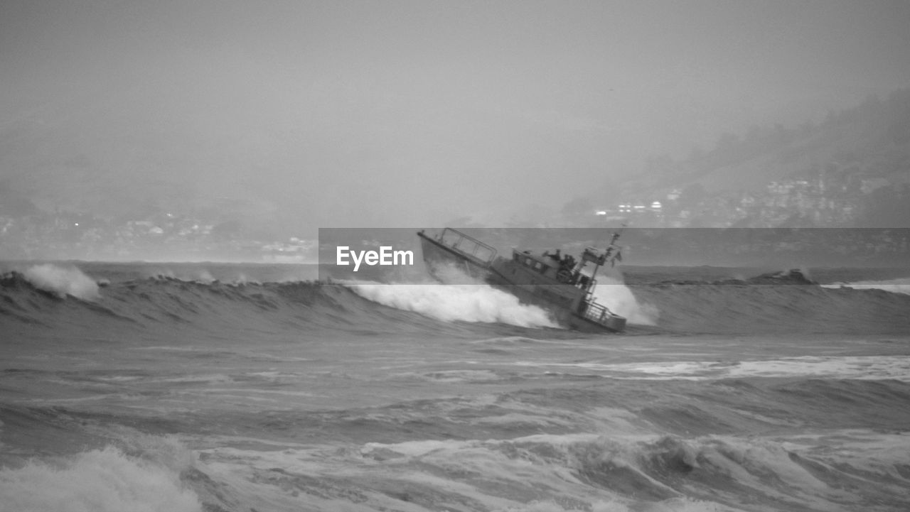 Boat sailing in sea against sky