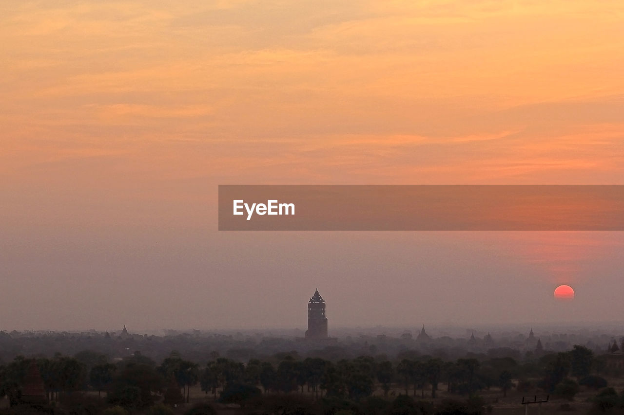 Tower of building against sky during sunset