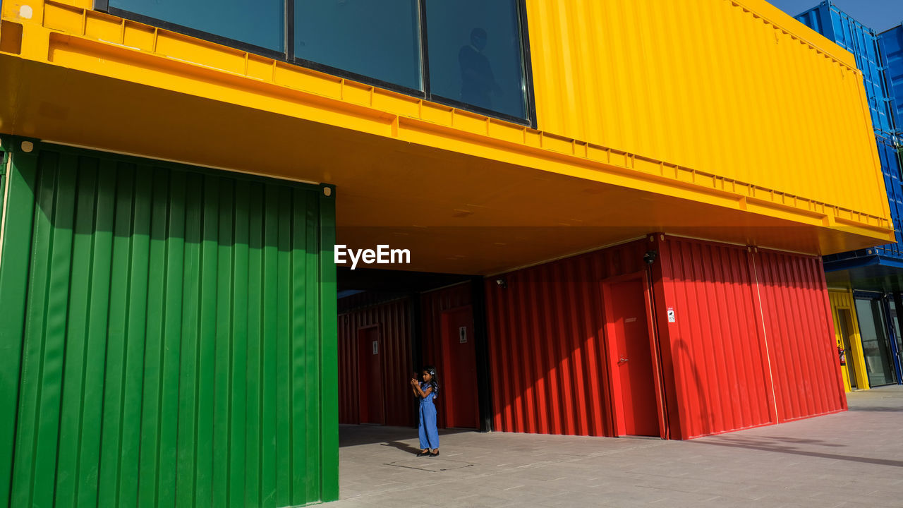 FULL LENGTH REAR VIEW OF MAN WALKING IN BUILDING