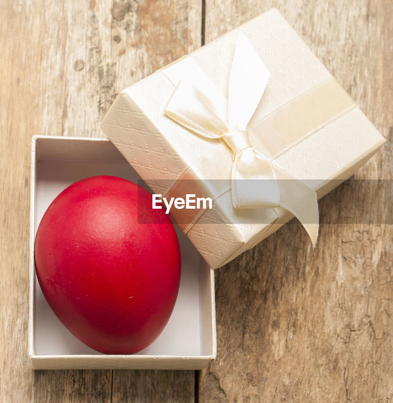 Close-up of red egg in box on table