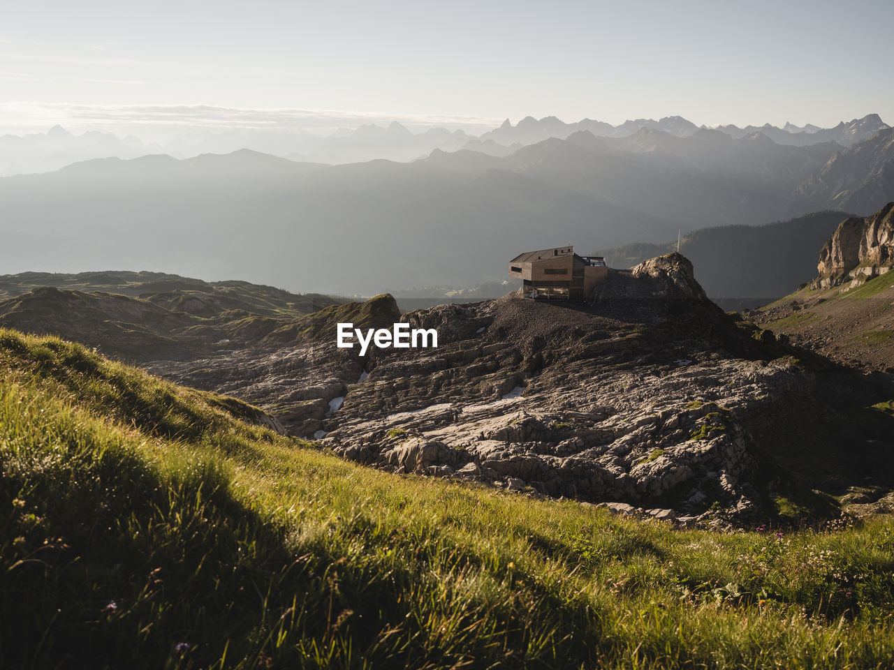 View of house on landscape against mountain range