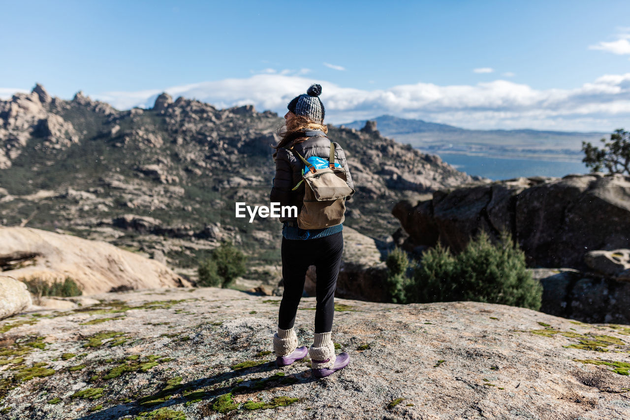 Rear view of woman standing on mountain