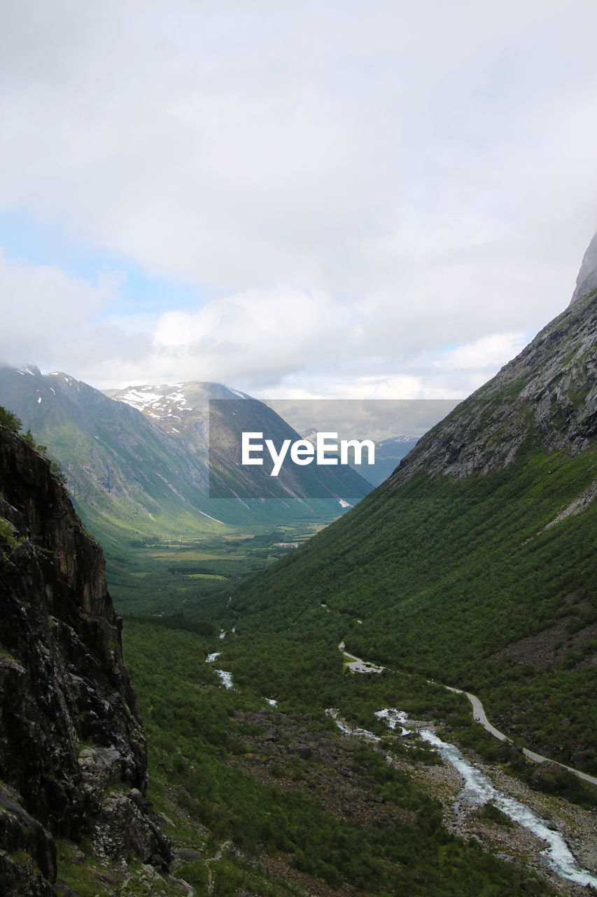 Scenic view of mountains against cloudy sky