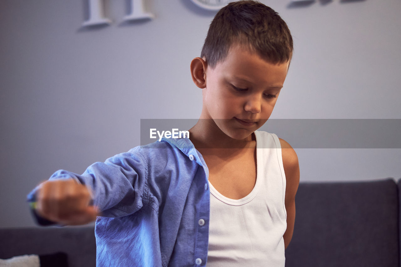 Boy looking at camera at home