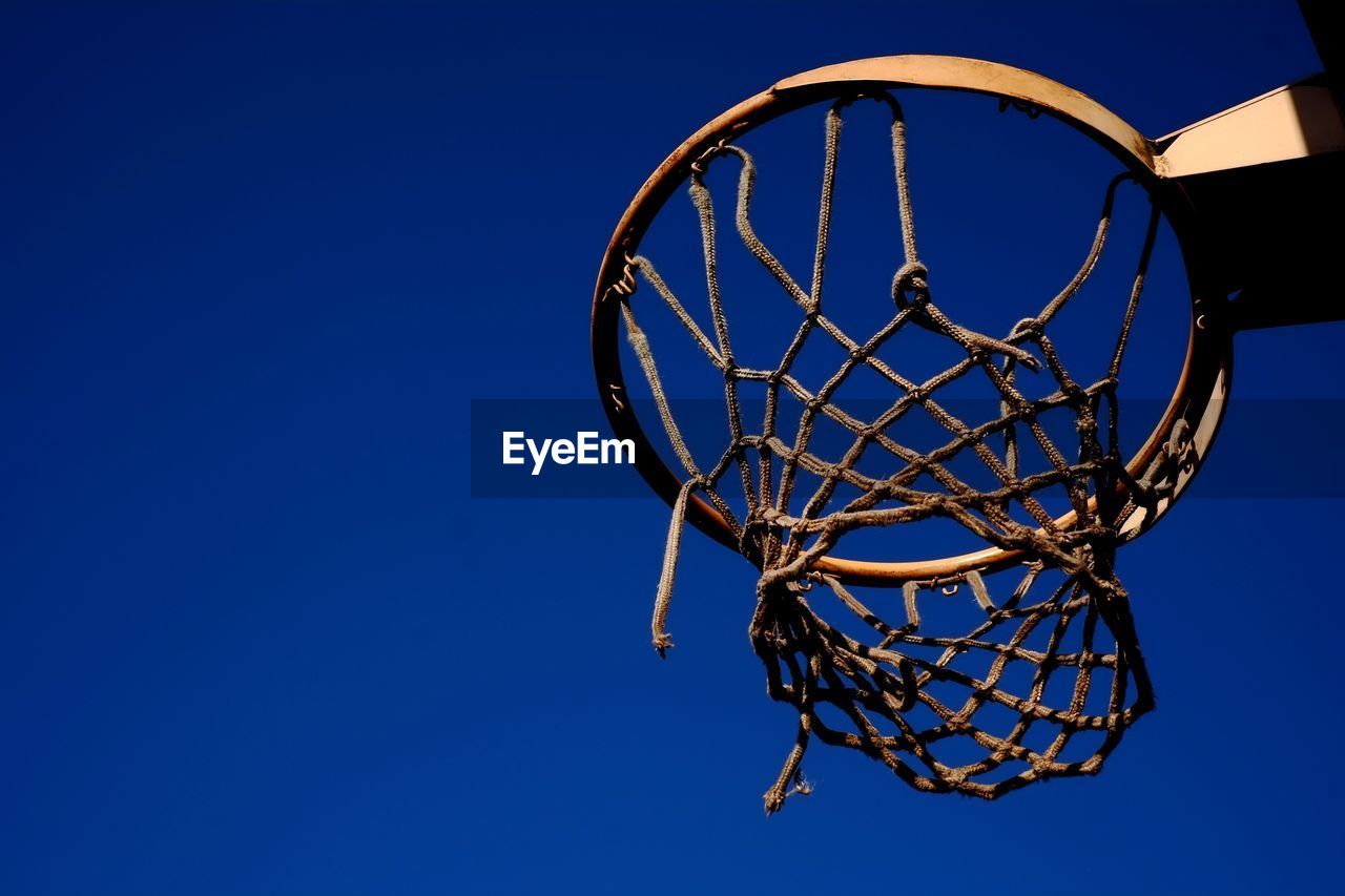 Low angle view of basketball hoop against blue sky