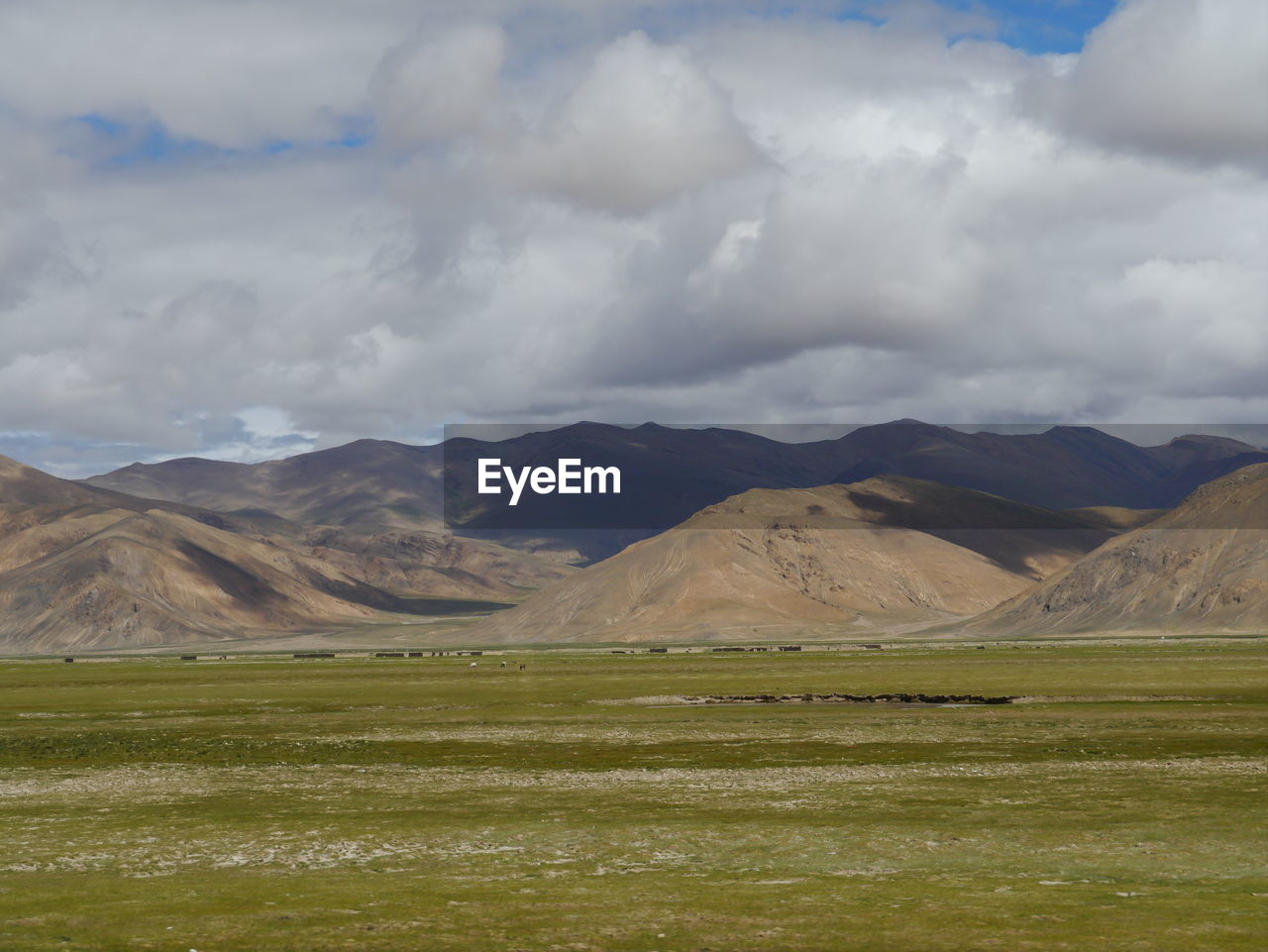 Countryside landscape against mountain range