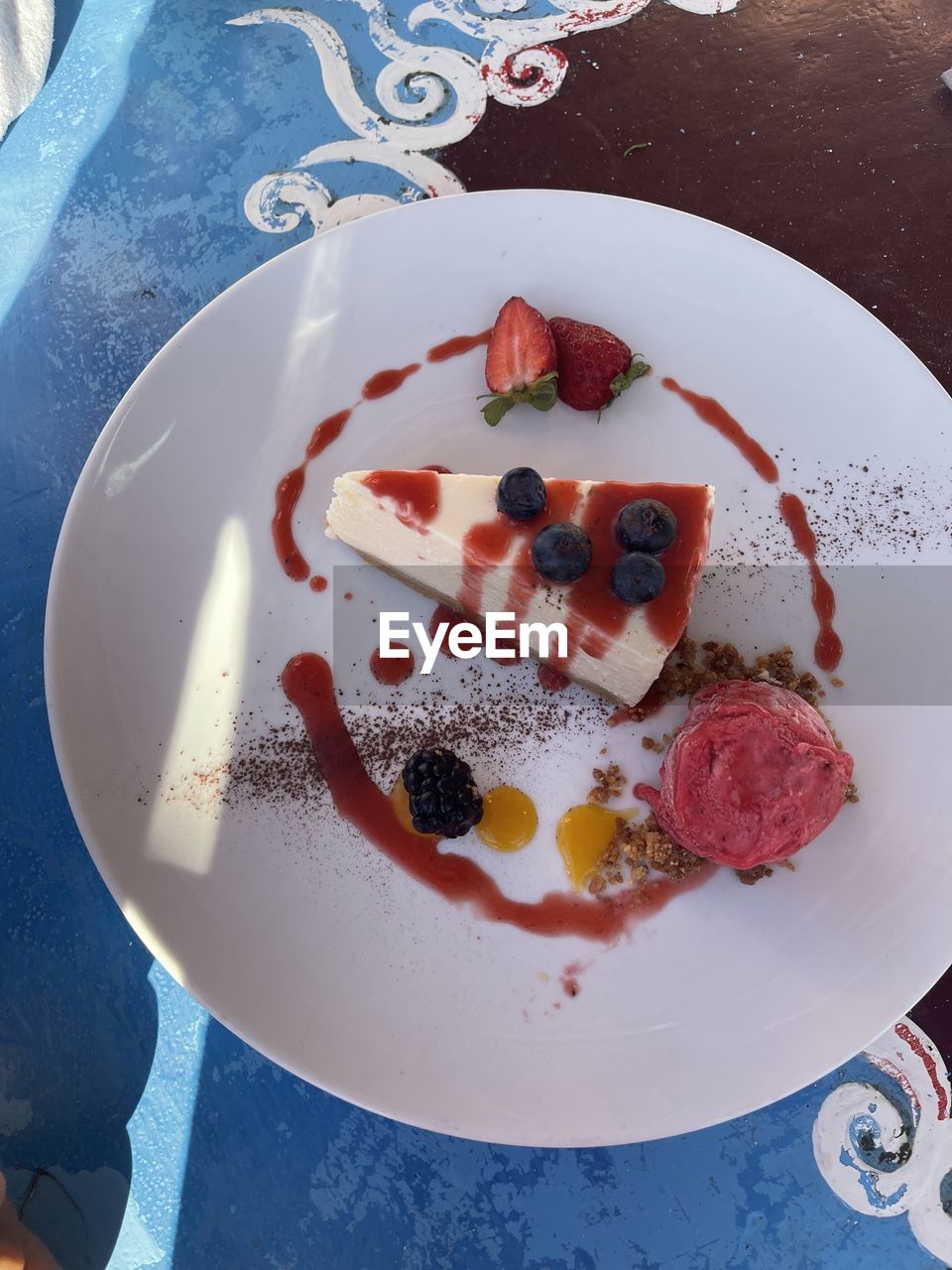 food, food and drink, plate, fruit, sweet food, freshness, sweet, berry, dessert, breakfast, high angle view, meal, table, healthy eating, no people, directly above, indoors, strawberry, still life, cake, produce, dairy, dish, blue