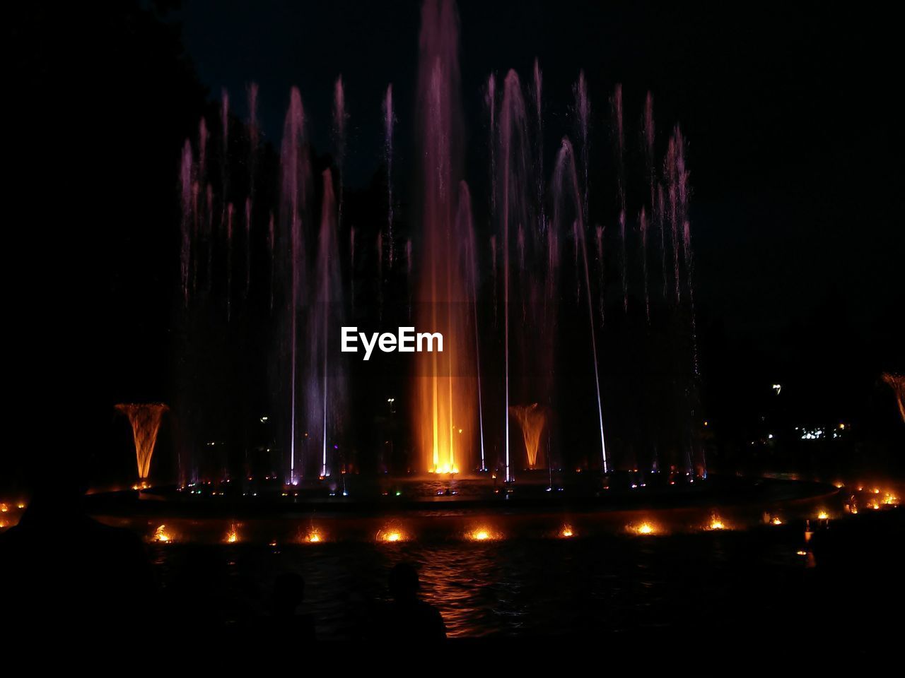 ILLUMINATED FOUNTAIN AT NIGHT