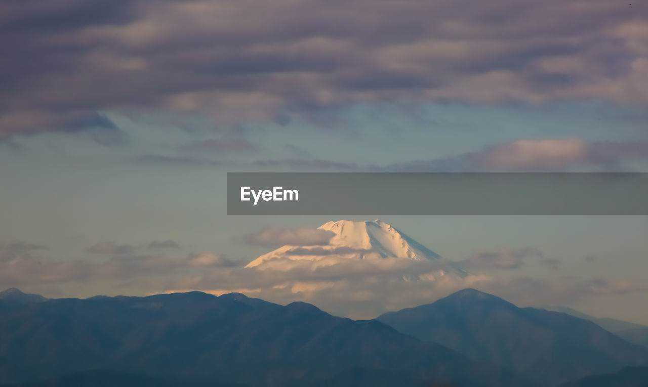 Scenic view of mountains against sky at sunset