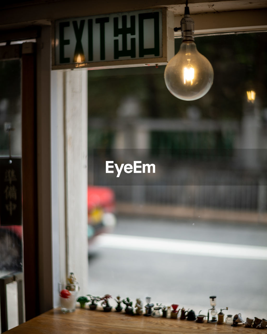 lighting equipment, illuminated, no people, indoors, architecture, interior design, table, focus on foreground, window, lighting, domestic room, cafe, night