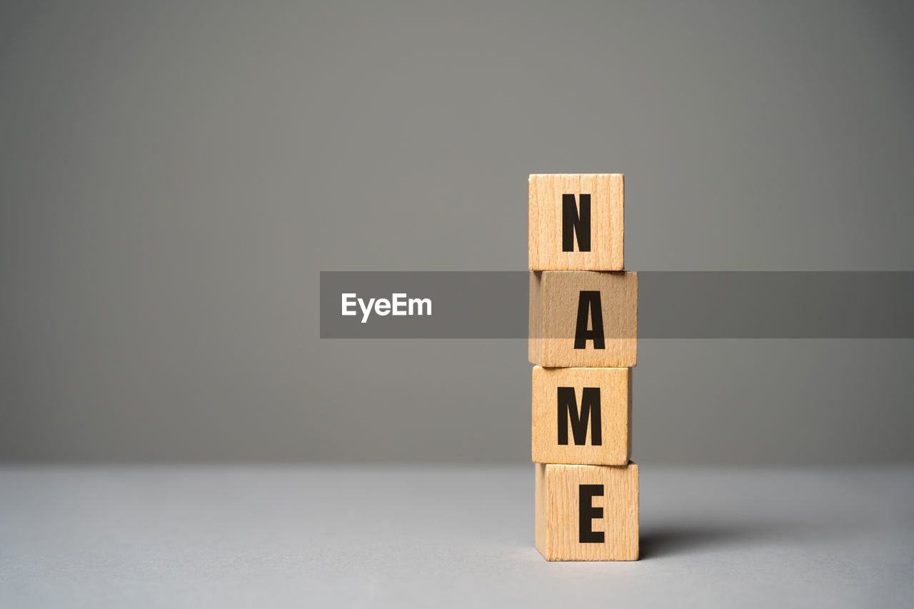 Name inscription on wooden blocks concept. creation of a new personal brand or name 