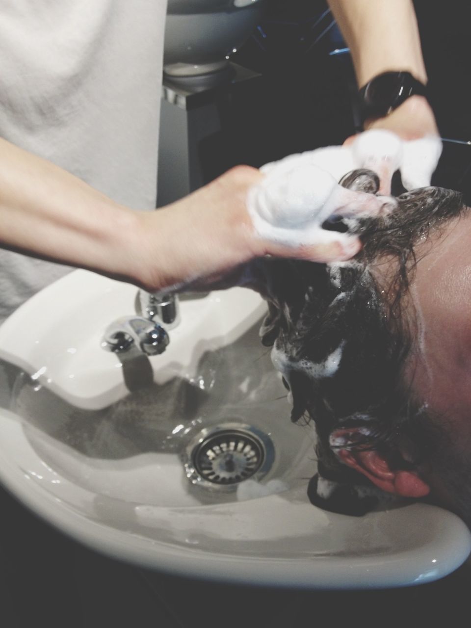 Man having hair washed