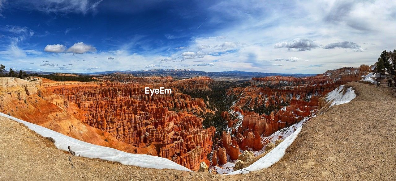 environment, landscape, scenics - nature, sky, cloud, travel destinations, travel, nature, beauty in nature, land, mountain, rock, tourism, non-urban scene, panoramic, no people, rock formation, desert, tranquility, wilderness, outdoors, canyon, tranquil scene, geology, extreme terrain, mountain range, valley, sunlight, day, plateau, national park, remote, blue, semi-arid, idyllic, snow, terrain, cold temperature, climate