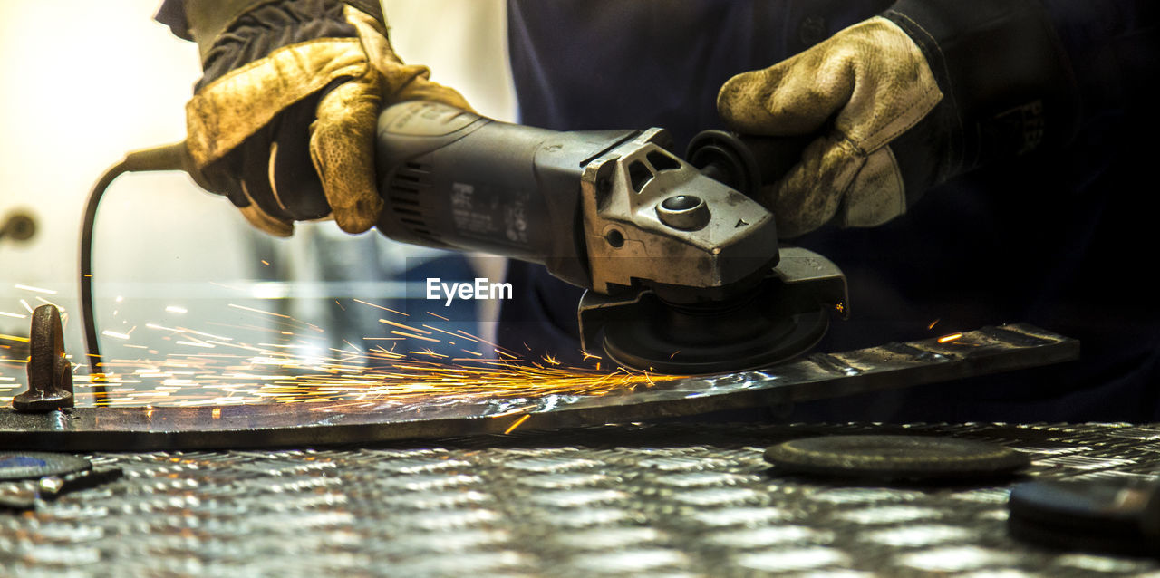 Midsection of worker working in workshop