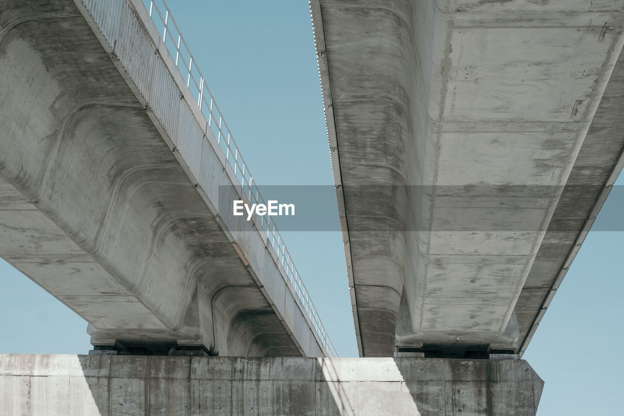 Low angle view of concrete bridge against clear sky