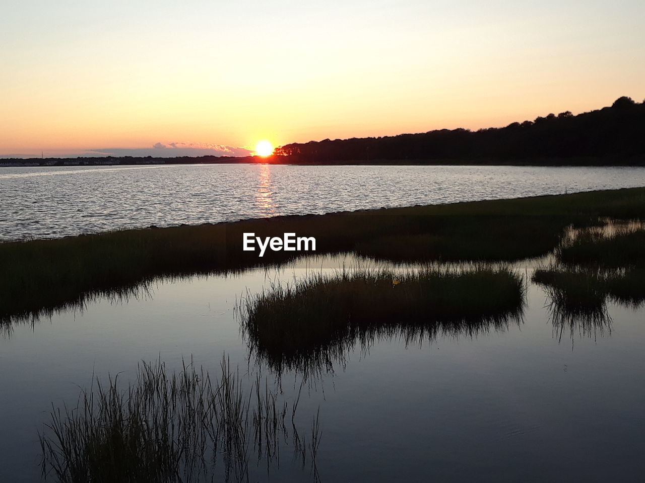 Scenic view of lake against sky during sunset