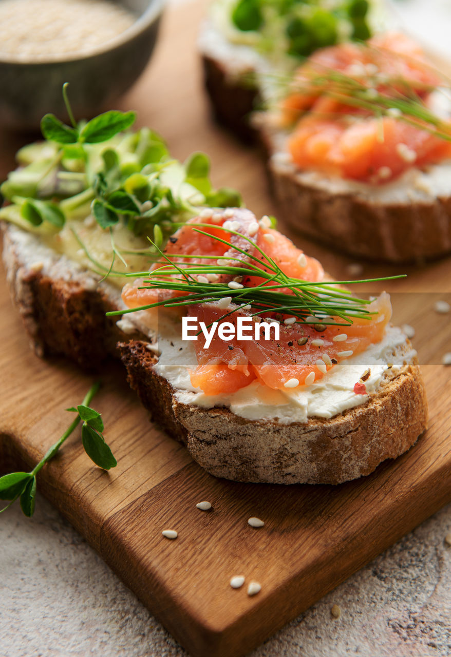 Sandwiches with salted salmon, avocado and microgreens. healthy food.