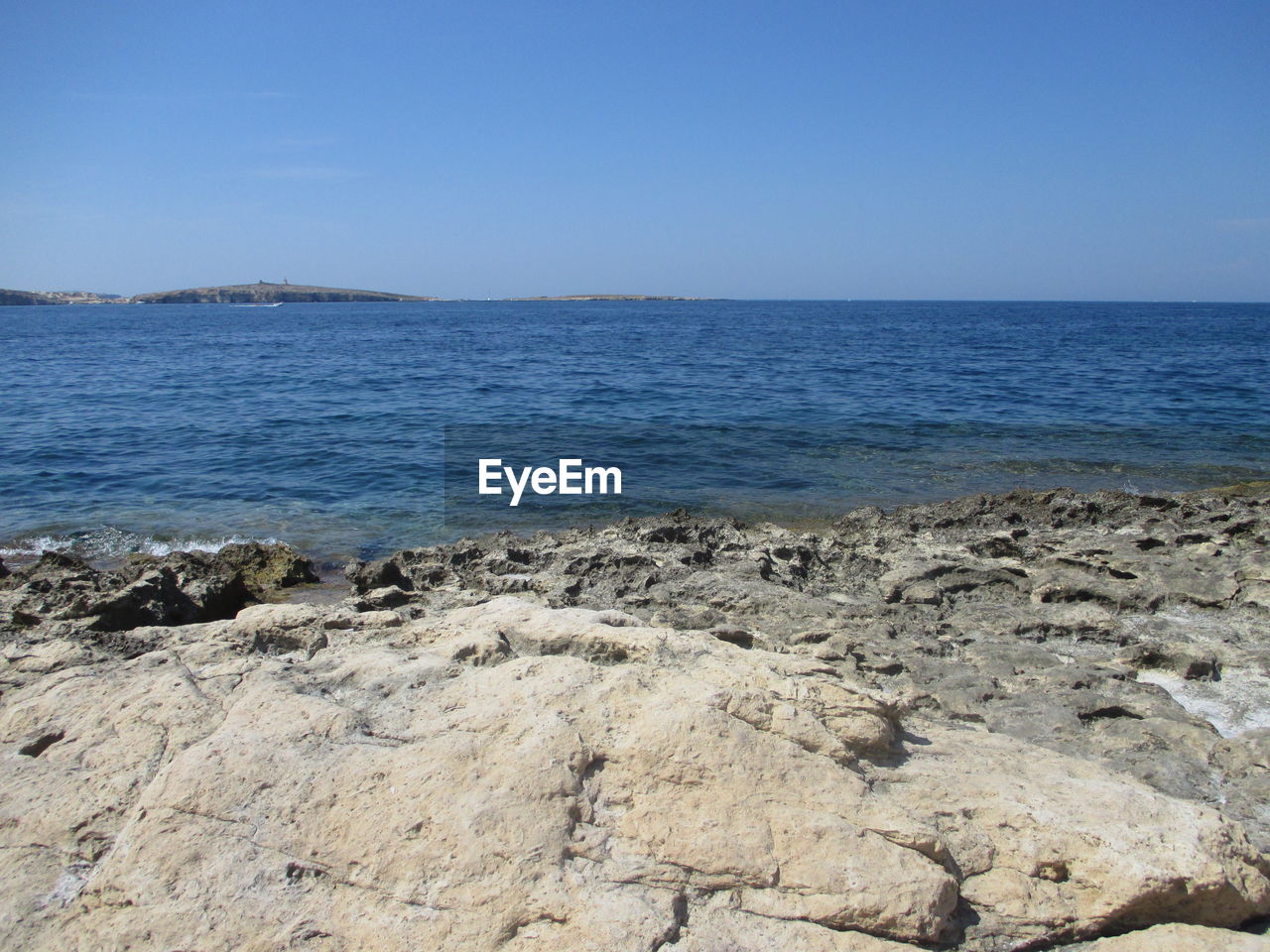 Scenic view of sea against clear blue sky