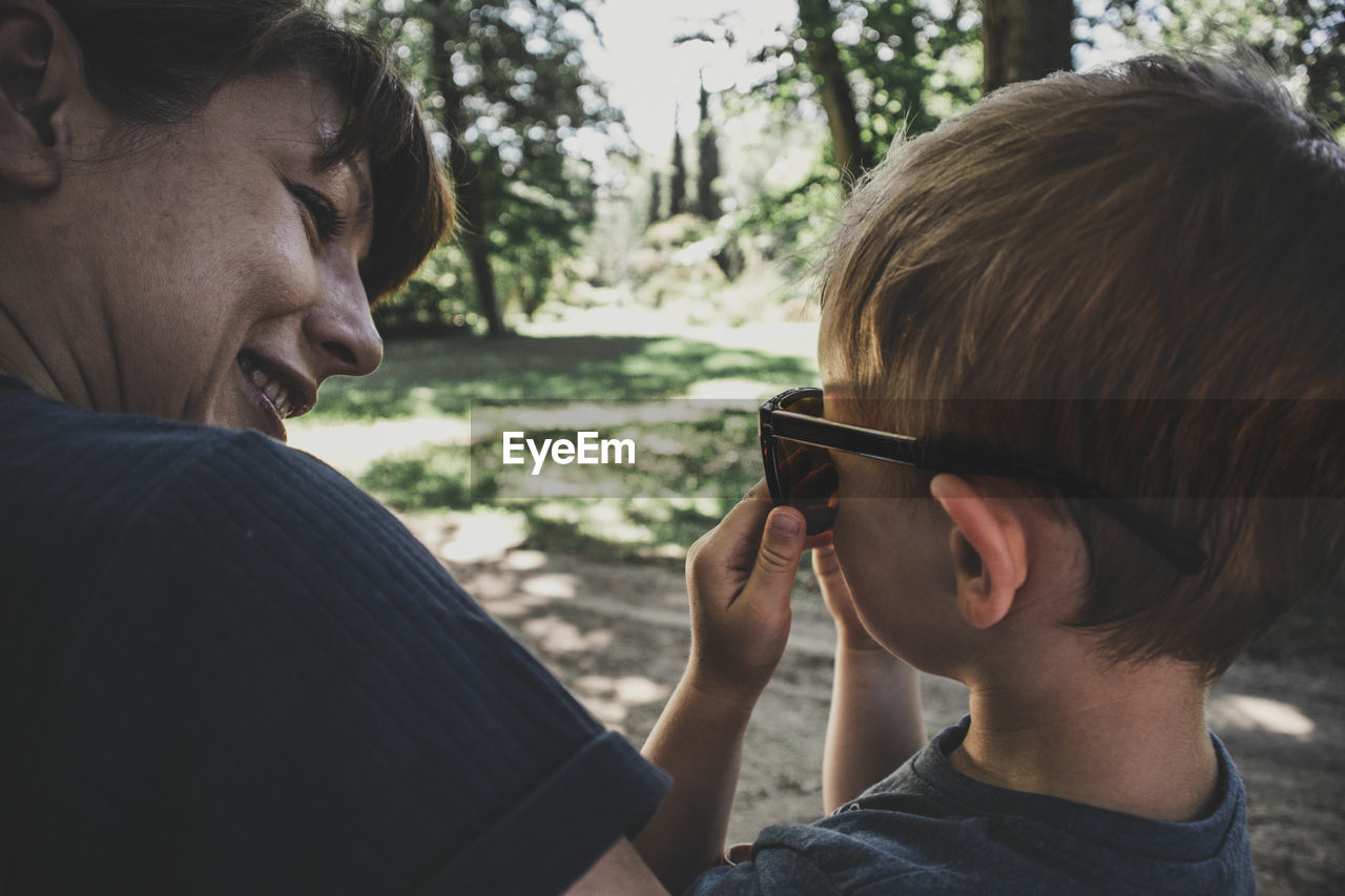 Portrait of mother and son siting in park