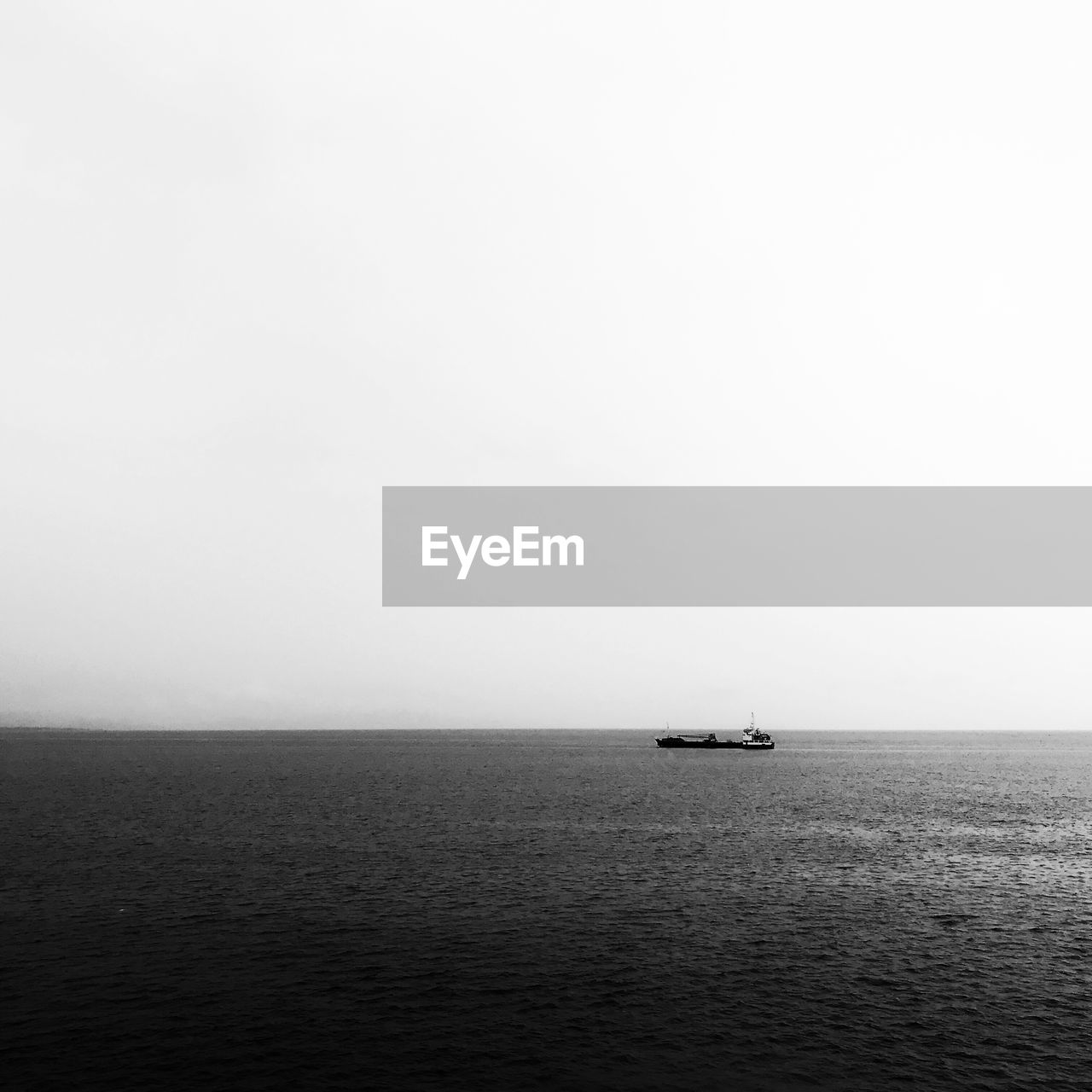 Sailboat sailing on sea against clear sky