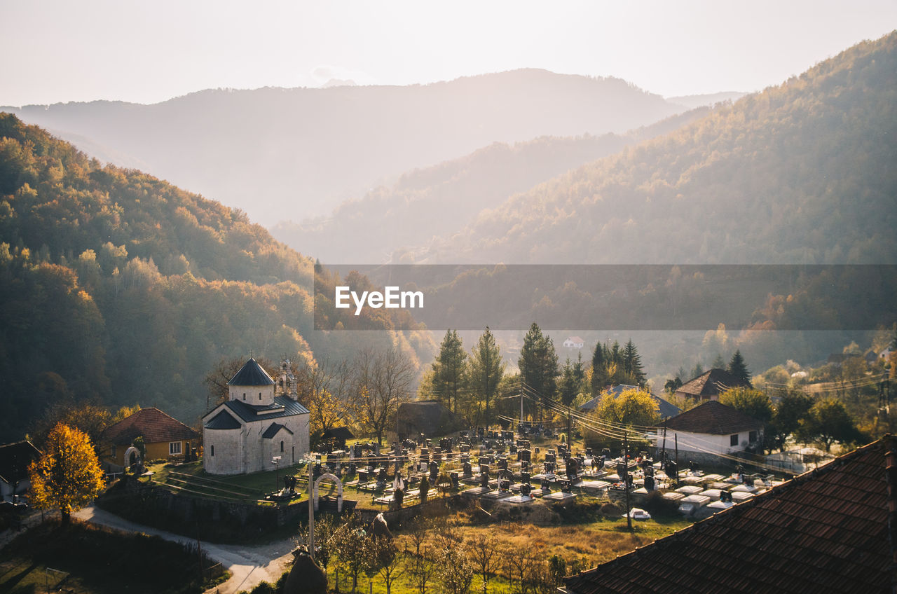 Panoramic shot of buildings and mountains against sky