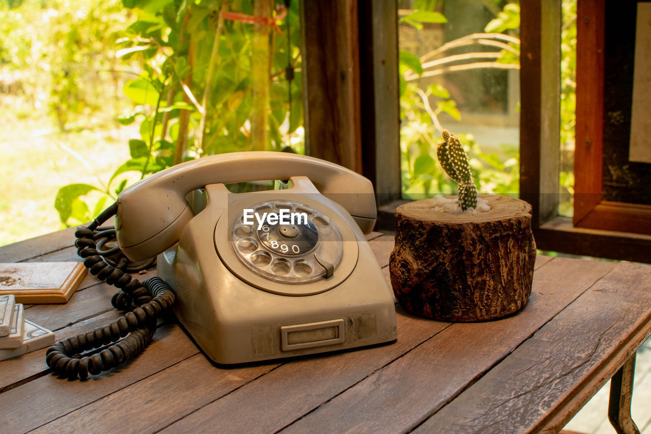 Close-up of old telephone on table