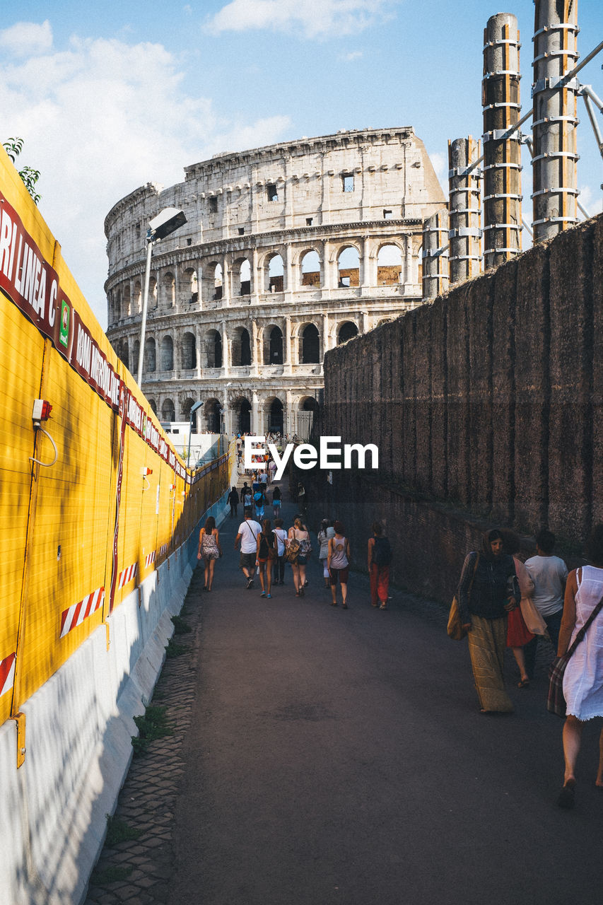 Tourists walking towards coliseum