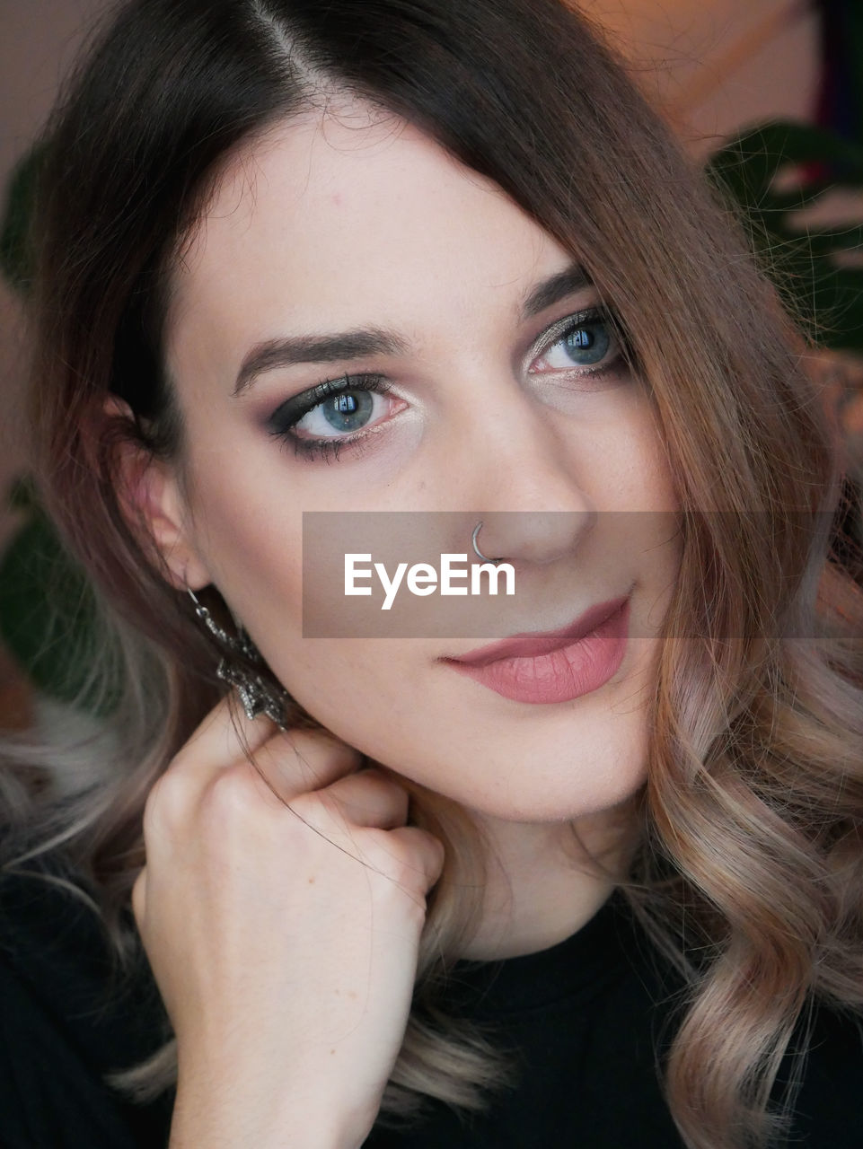 Close-up portrait of beautiful young woman looking away