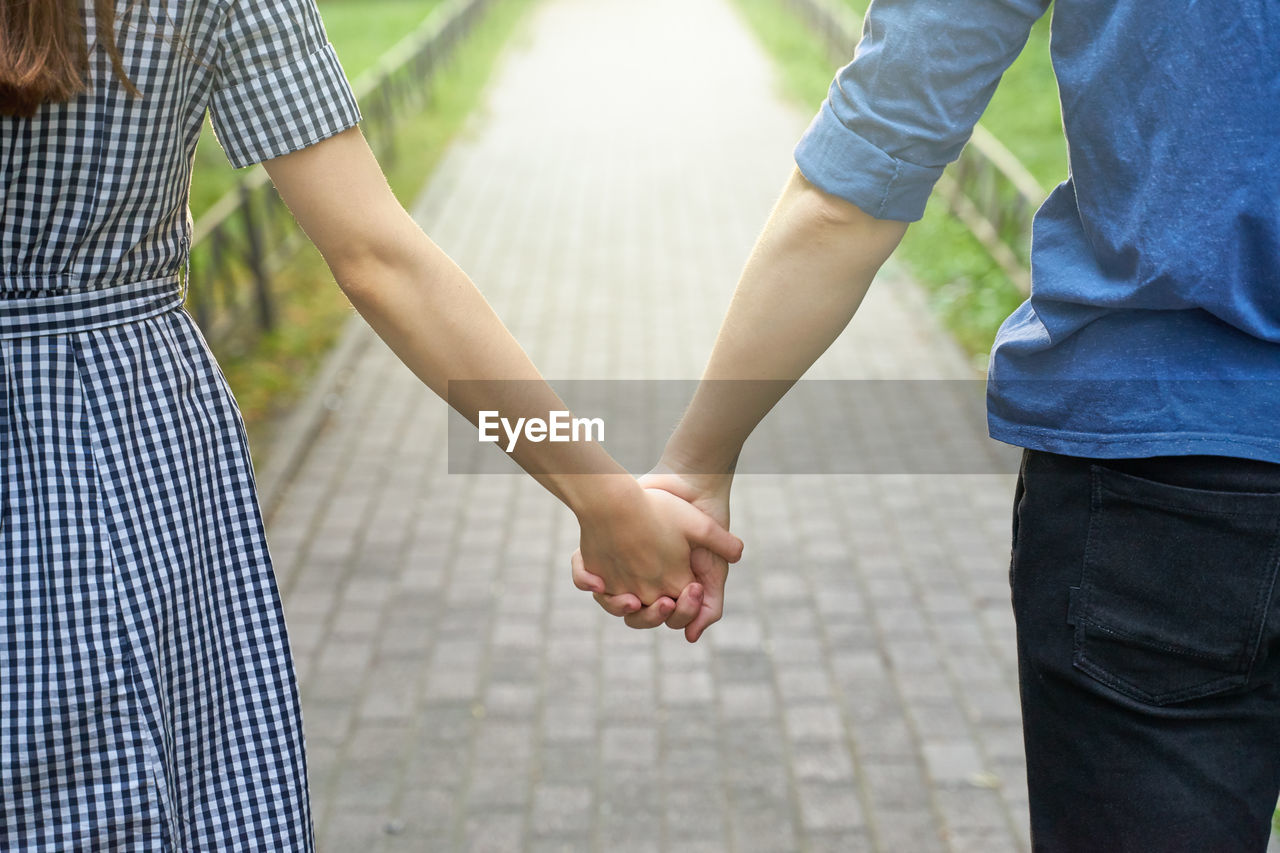 MIDSECTION OF MAN AND WOMAN STANDING AT OFFICE