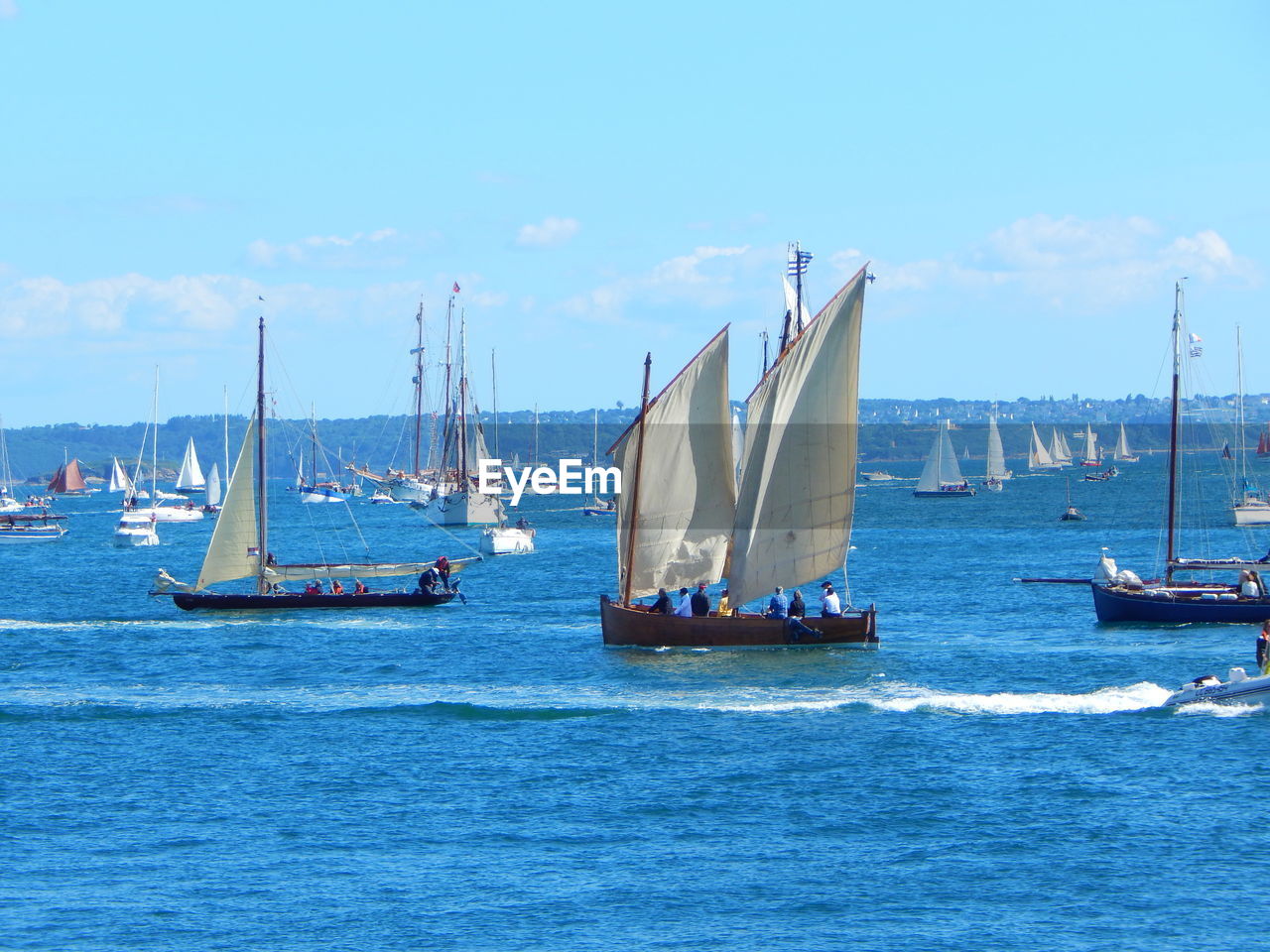 Boats sailing in sea against sky