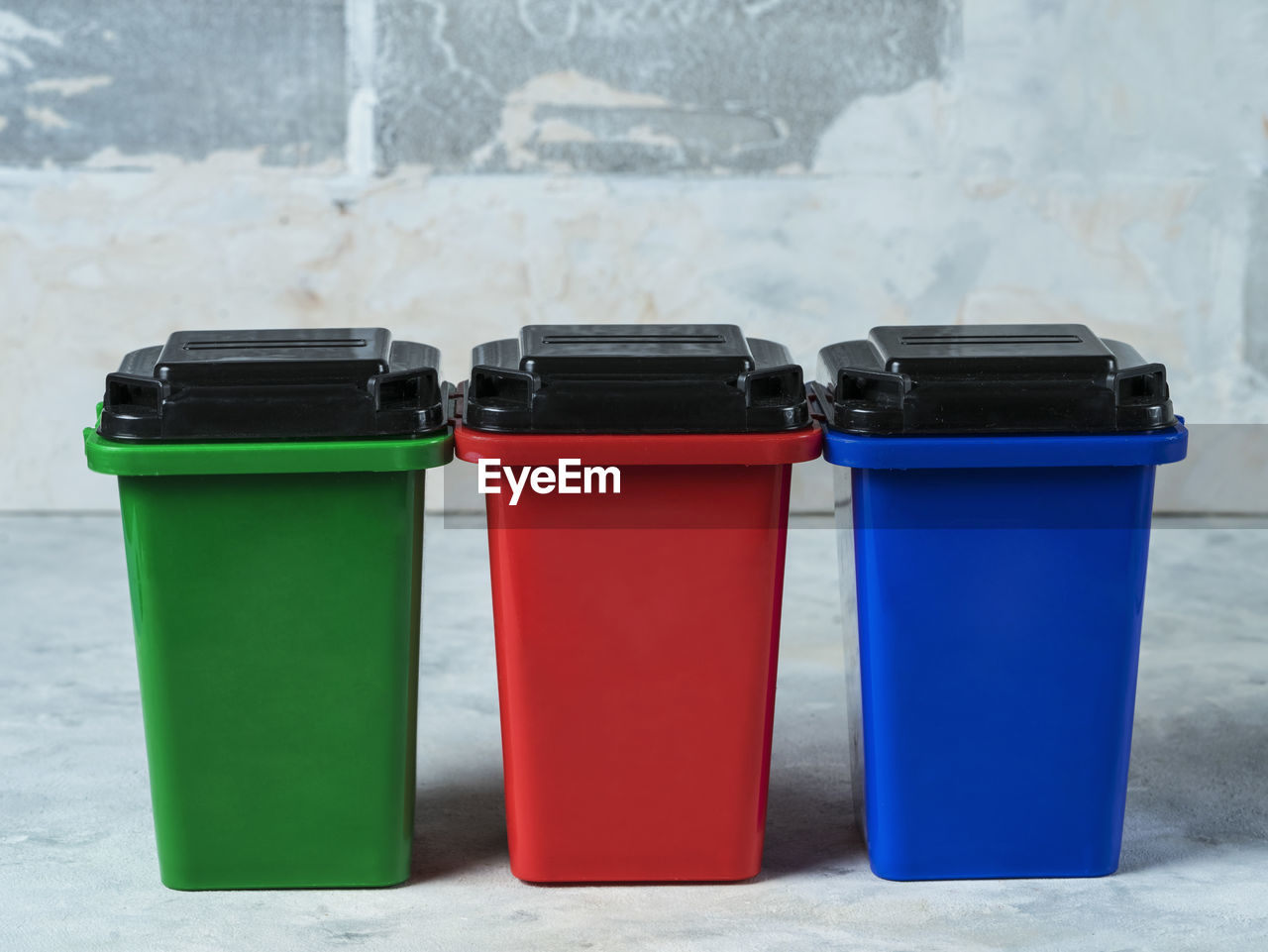 Green, red, blue dumpsters. garbage sorting concept