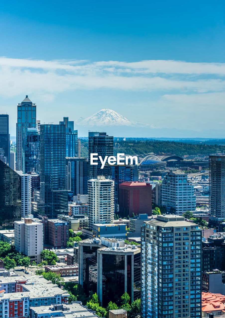 Tall buildings in downtown seattle, washington with mount rainier in the distance