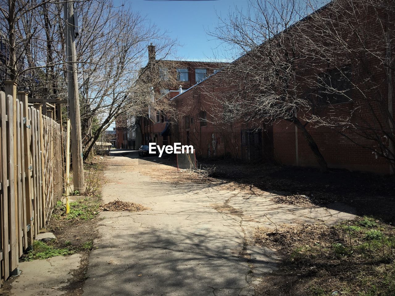 EMPTY ROAD AMIDST BUILDINGS