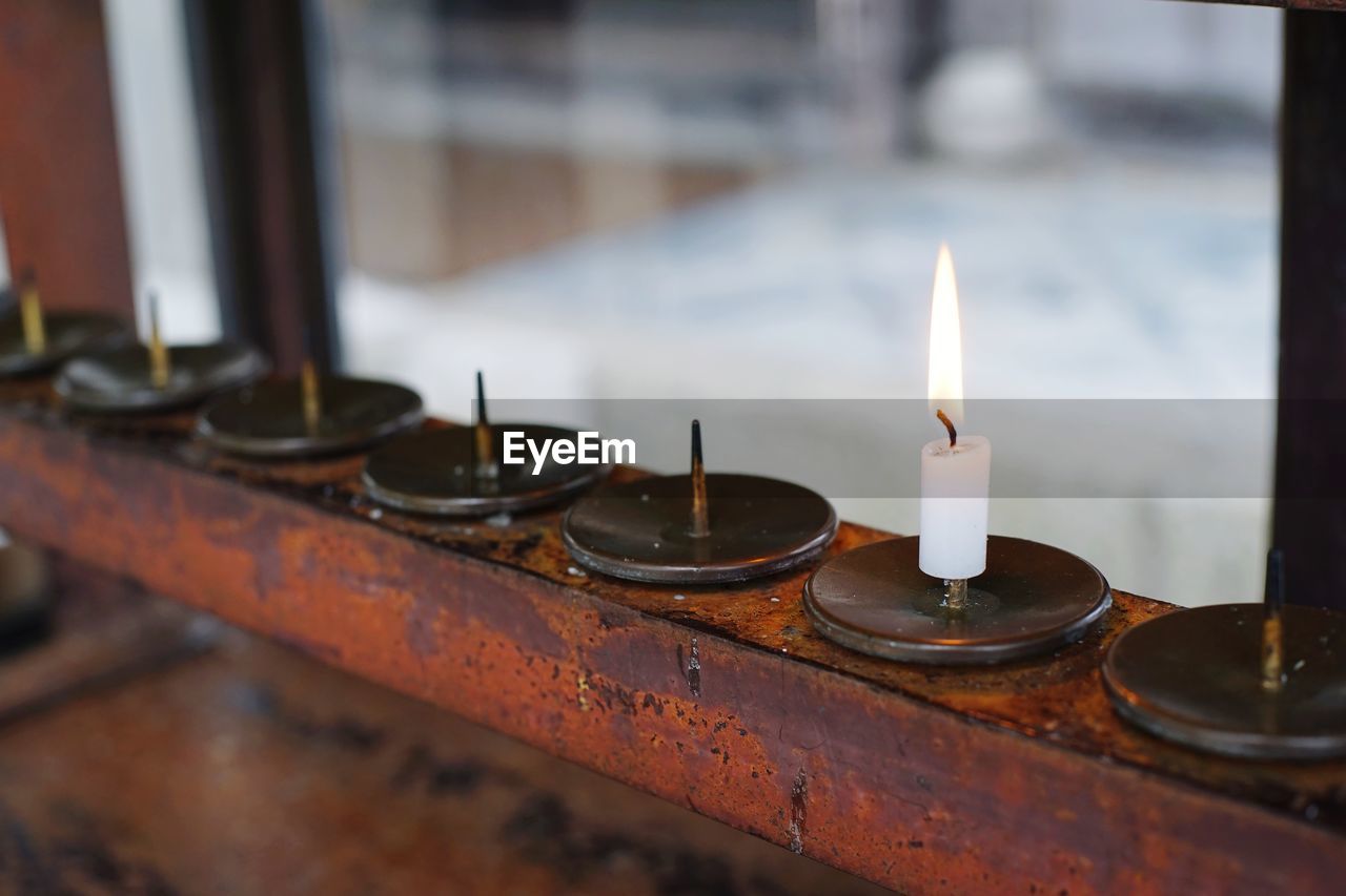 Close-up of illuminated candles on table