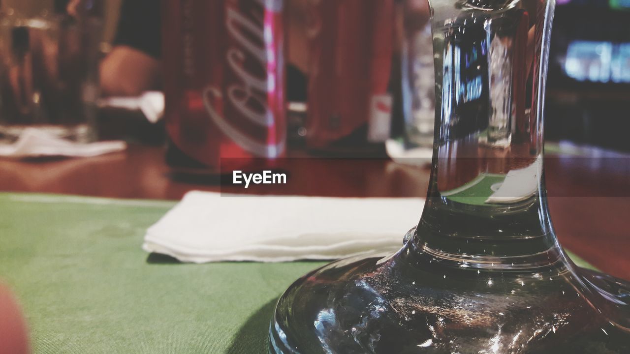 CLOSE-UP OF WINE BOTTLE ON TABLE