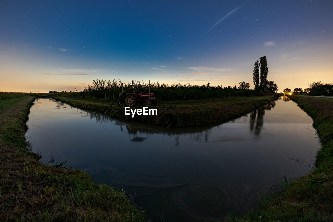 Scenic view of a little river against sky at sunset