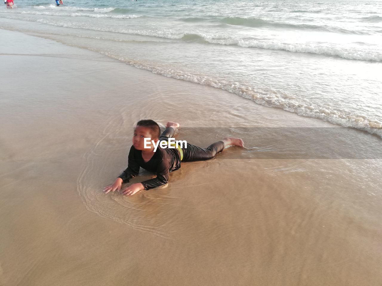 HIGH ANGLE VIEW OF MAN SURFING ON BEACH