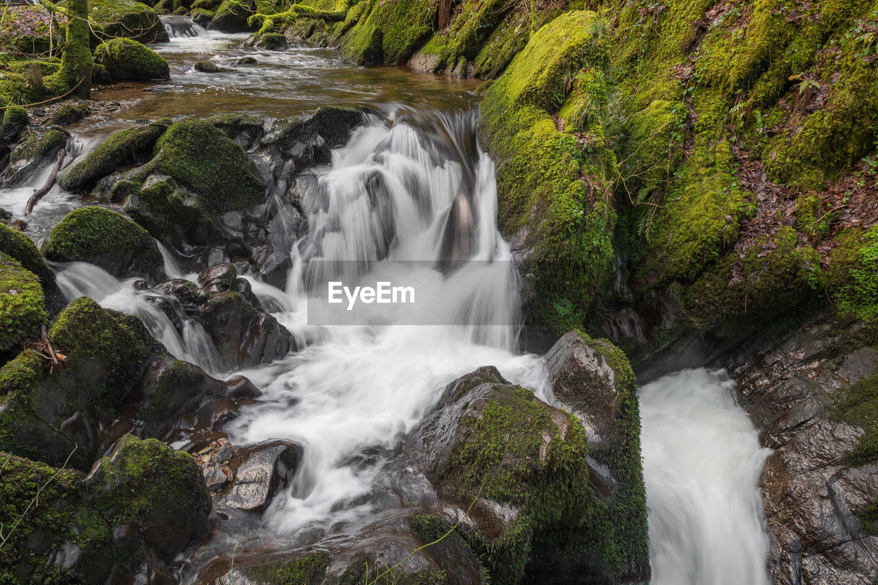 Long exposure of a waterfall flowing over rocks at watersmeet in exmoor national park