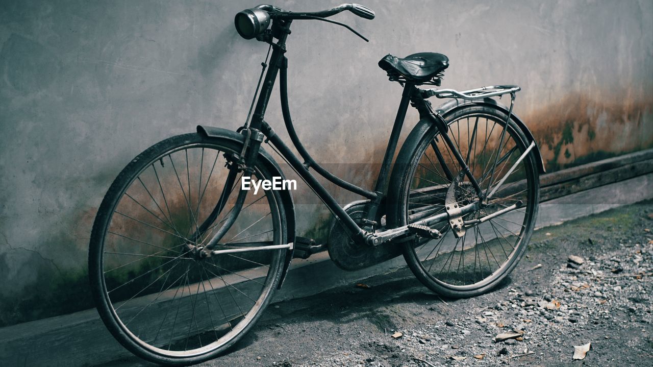 Bicycle leaning against wall