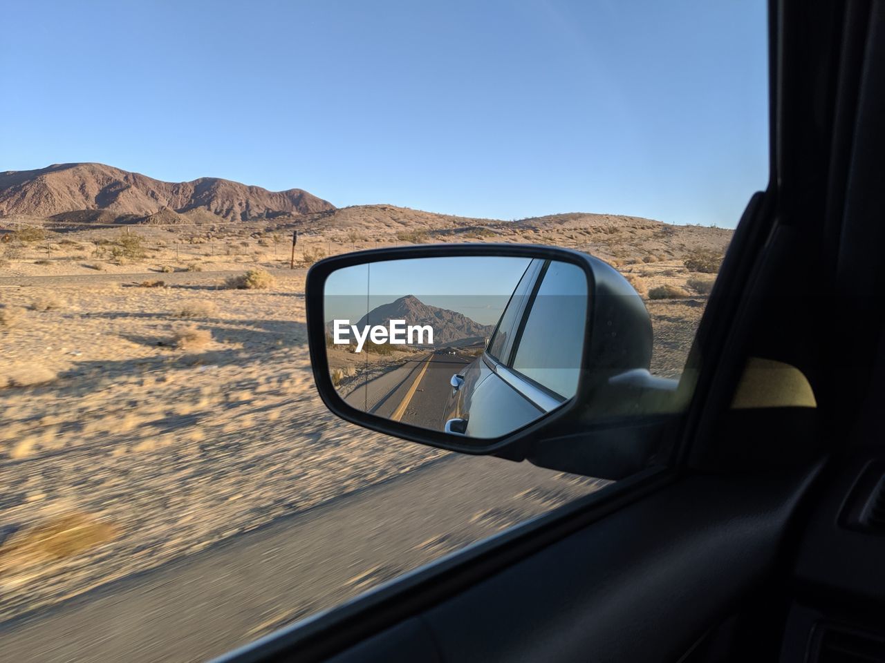 Reflection of car on side-view mirror