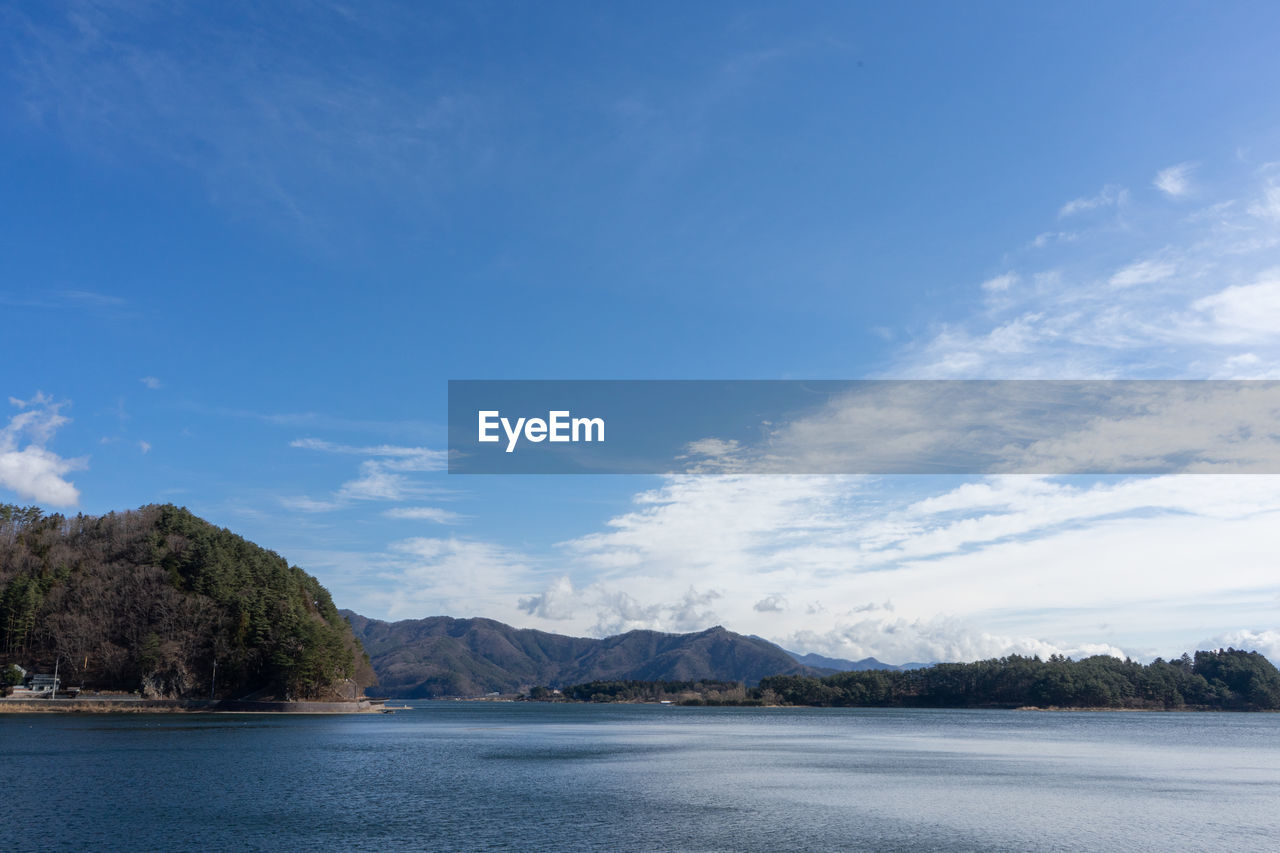 Scenic view of sea and mountains against sky